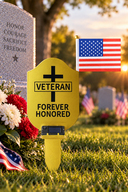 Gold metal Veteran Grave Marker with solar light and American flag at a cemetery